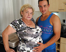 Curvy granny sucking and fucking a way younger dude in her kitchen